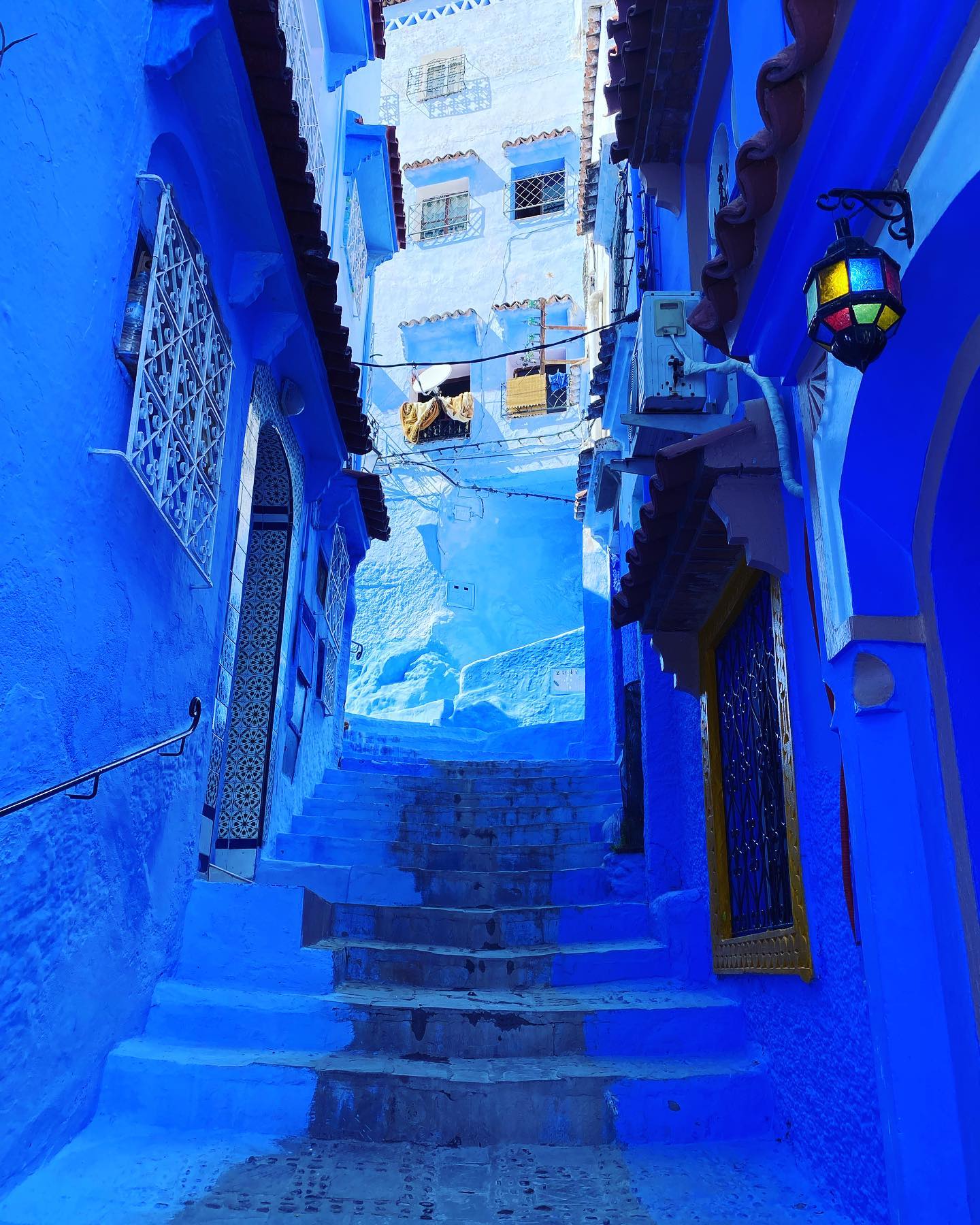 A quiet blue-painted alley in the Chefchaouen medina.