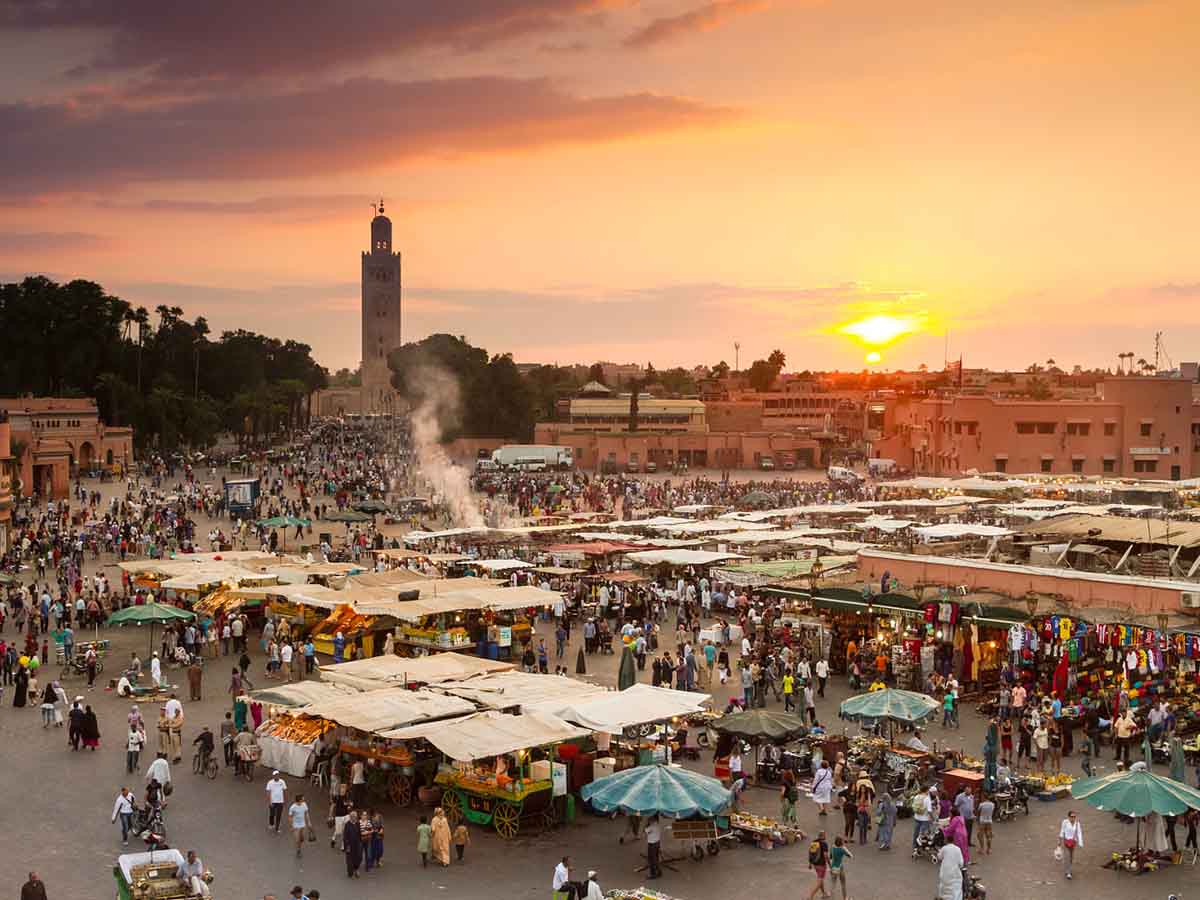 A Moroccan feast spread beneath a palm shelter in Marrakech.
